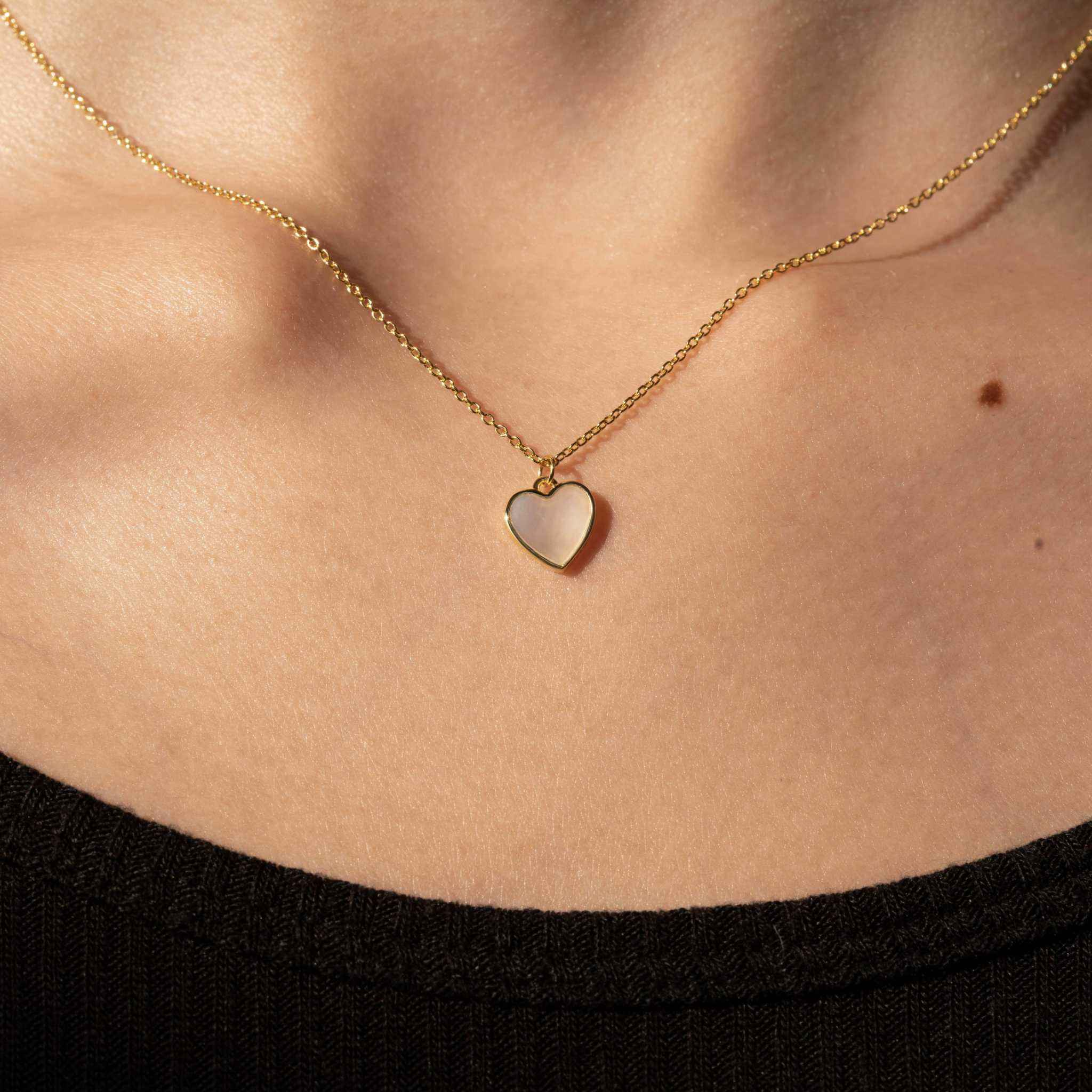 Seashell Serenity Necklace with heart-shaped mother of pearl pendant on 18K gold finish chain.