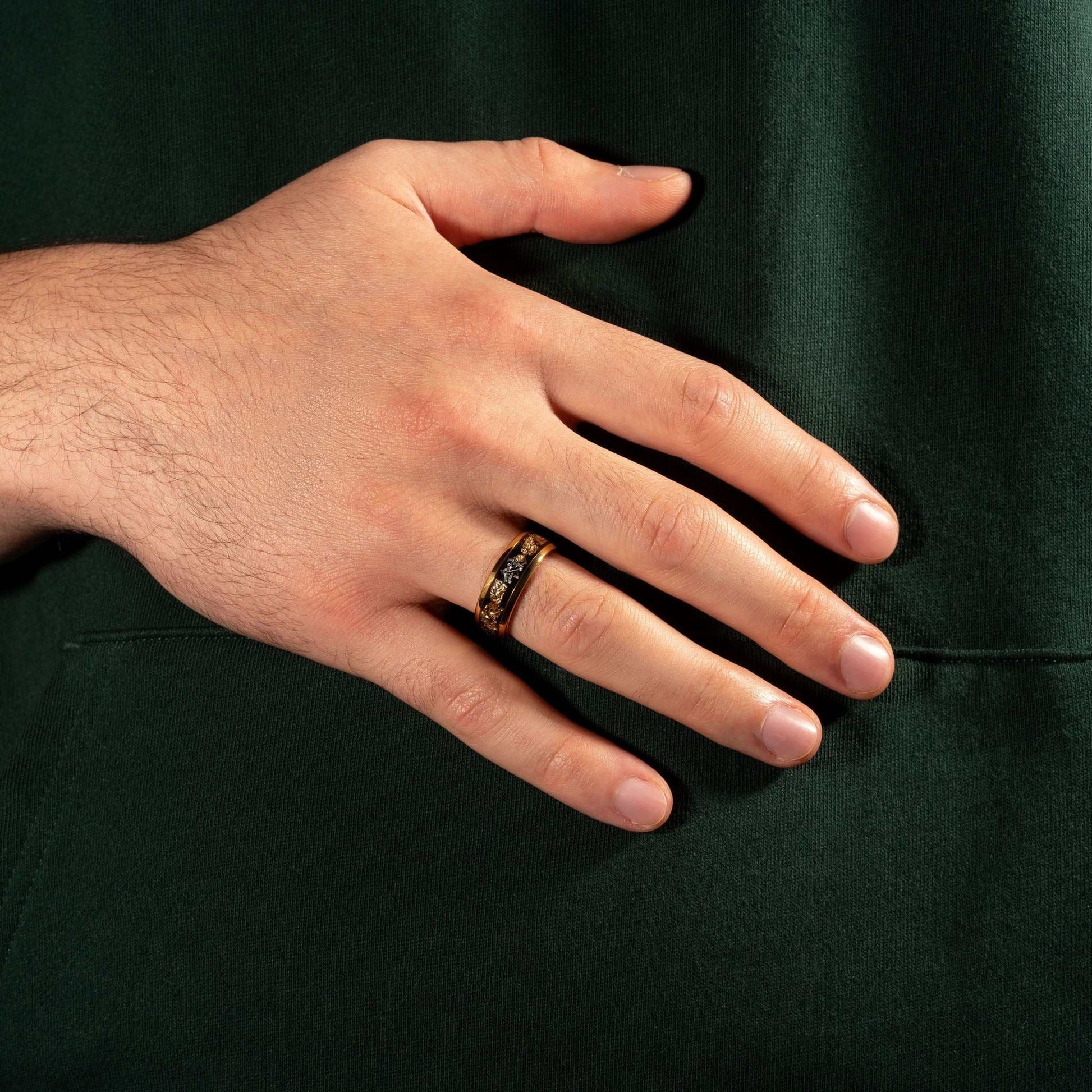 Meteorite Gold Leaf Ring on hand, showcasing tungsten setting with meteorite and 22K gold inlay.