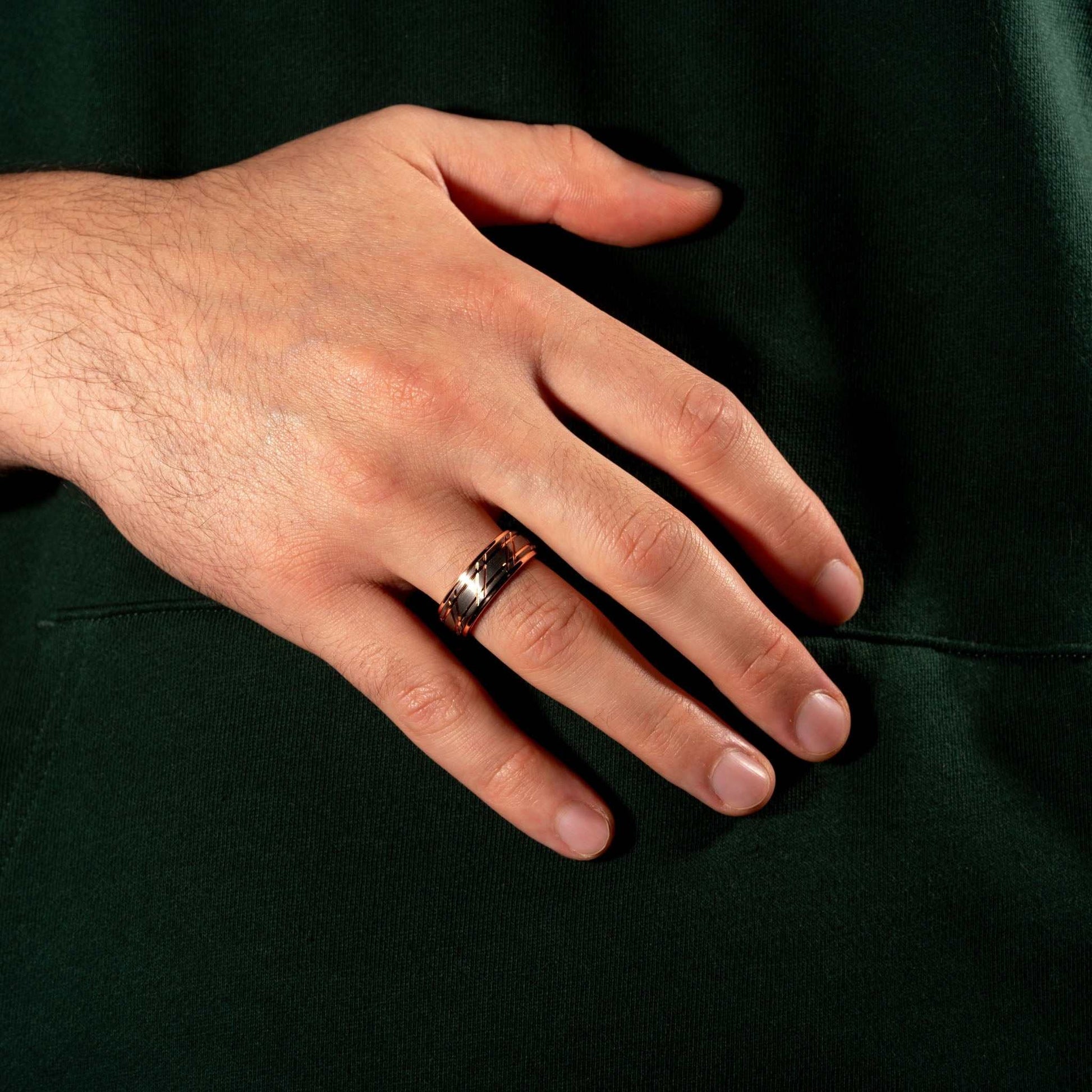 Rose gold men's wedding band with hammered texture and polished finish.